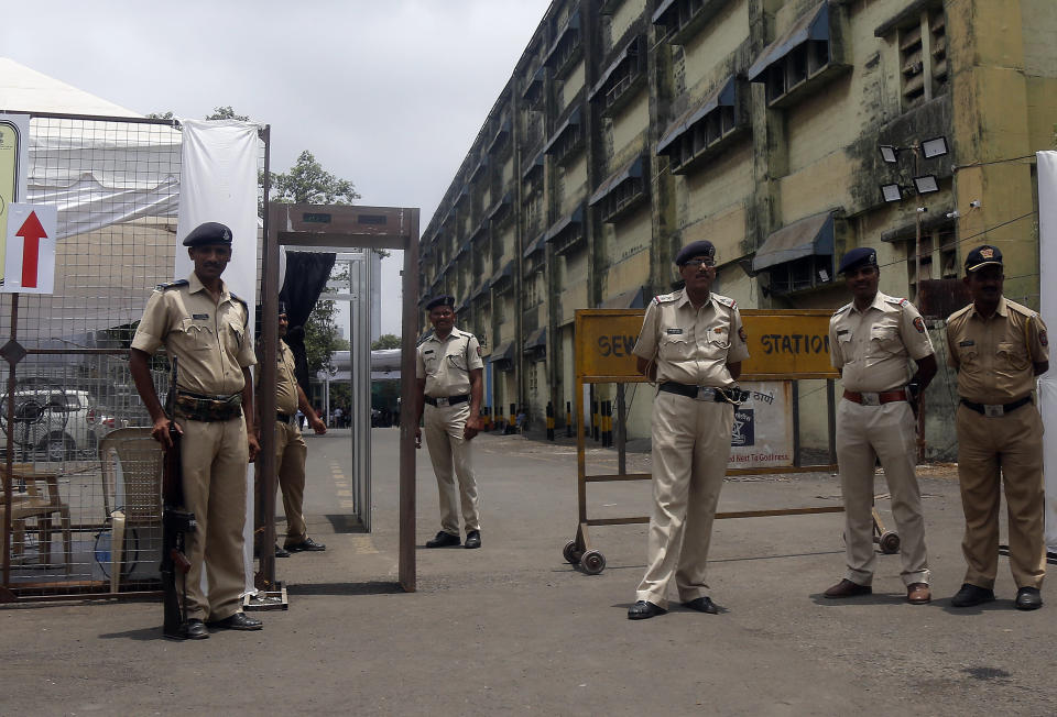 FILE- In this Tuesday, May 21, 2019 file photo, security officials keep vigil outside a vote counting center in Mumbai, India. India's Election Commission has rejected opposition fears of possible tampering of electronic voting machines ahead of Thursday's vote-counting to determine the outcome of the country's mammoth national elections. Authorities on Wednesday tightened security at counting centers where the electronic voting machines have been kept in strong rooms across the country. (AP Photo/Rajanish Kakade, File)