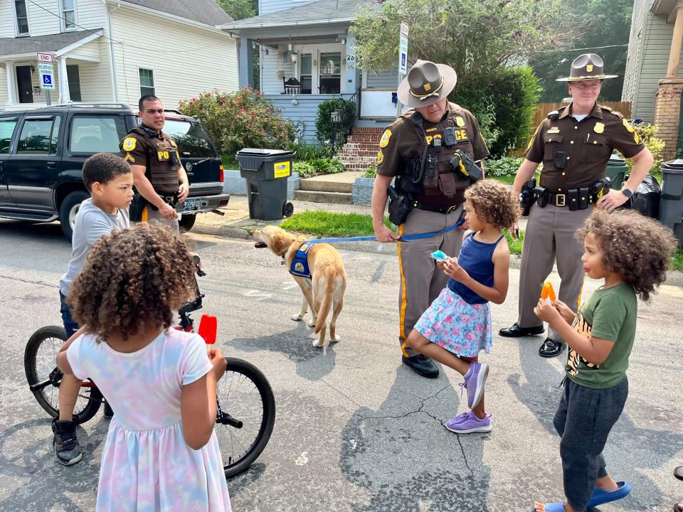 New Castle County police speak with children in Knollwood during a peace walk on Thursday, June 29, 2023.