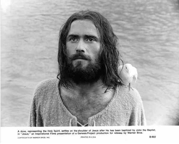 Brian Deacon with a dove on his shoulder in a scene from the film 'Jesus', 1979.