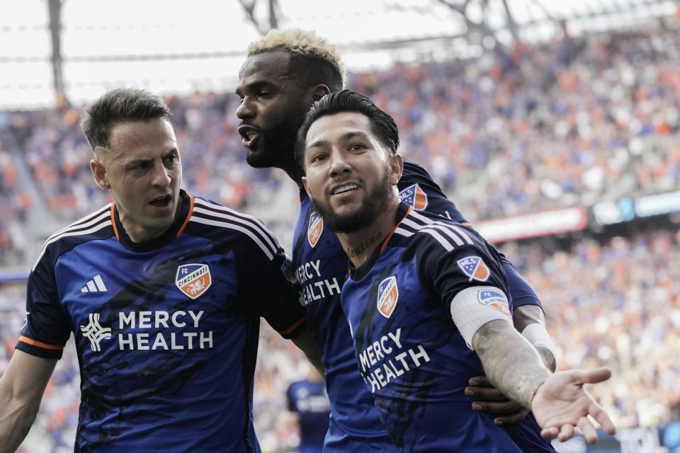 FC Cincinnati midfielder Luciano Acosta, right, celebrates his goal against Inter Miami with Aaron Boupendza, center, and Santiago Arias, left, during the first half of a U.S. Open Cup soccer semifinal Wednesday, Aug. 23, 2023, in Cincinnati. (AP Photo/Joshua A. Bickel)