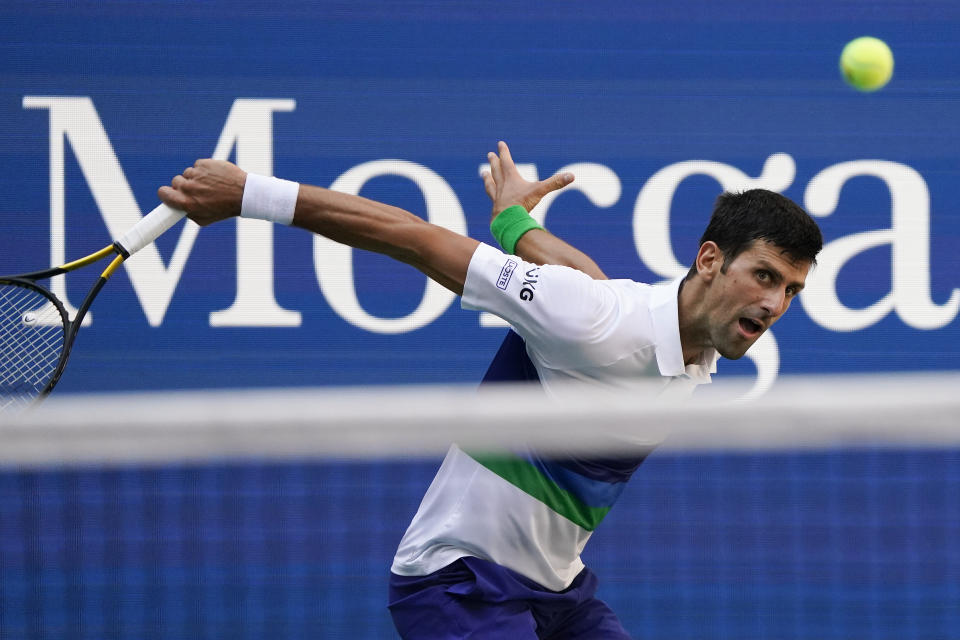 Novak Djokovic, of Serbia, returns a shot to Kei Nishikori, of Japan, during the third round of the US Open tennis championships, Saturday, Sept. 4, 2021, in New York. (AP Photo/John Minchillo)