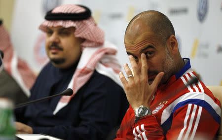 Bayern Munich's coach Pep Guardiola (R) attends a news conference in Riyadh January 17,2015. REUTERS/Faisal AlNasser