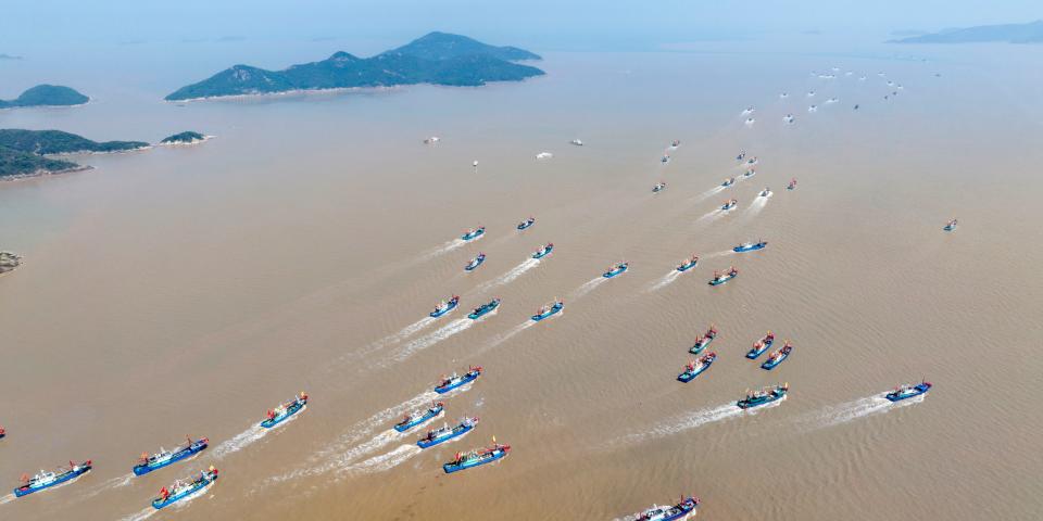 An aerial photo shows nearly 1,000 fishing boats crossing the Xiangshan Port cross-Sea Bridge on their way to the East China Sea to start fishing in Ningbo, Zhejiang Province, China, Sept 16, 2022