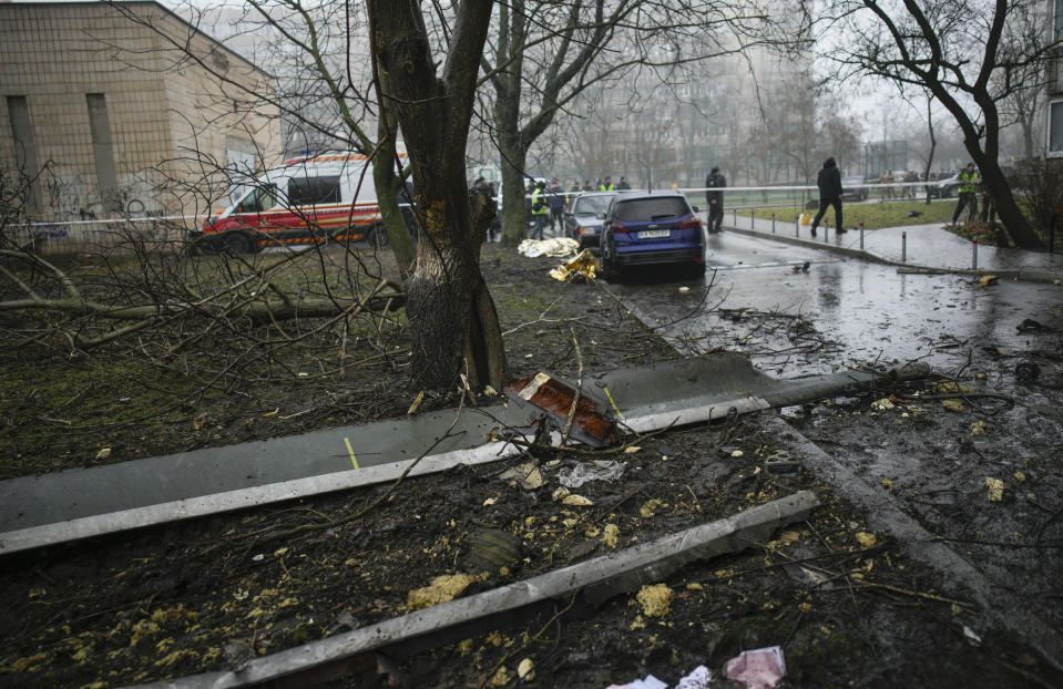 A helicopter blade on the ground at the scene where a helicopter crashed on civil infrastructure in Brovary, on the outskirts of Kyiv, Ukraine, Wednesday, Jan. 18, 2023. The chief of Ukraine's National Police says a helicopter crash in a Kyiv suburb has killed 16 people, including Ukraine's interior minister and two children. He said nine of those killed were aboard the emergency services helicopter. (AP Photo/Daniel Cole)