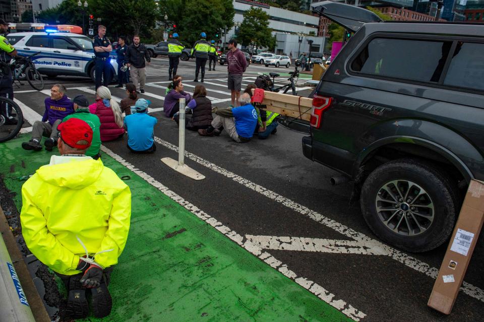 Climate activists from the group Extinction Rebellion block traffic in Boston, Massachusetts, on Wednesday, Sept. 21, 2022.