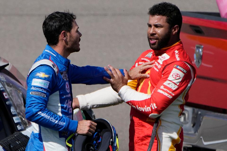 Bubba Wallace, right, and Kyle Larson shove each other away after the two crashed during a NASCAR Cup Series playoff race, Sunday at Las Vegas Motor Speedway.