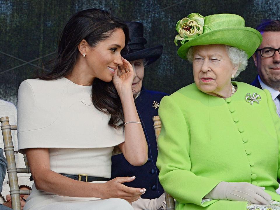 <p>In this file photo taken on June 14, 2018 Britain's Queen Elizabeth II and Meghan, Duchess of Sussex open the Mersey Gateway Bridge.</p> ((Photo by Jim CLARKE / POOL / AFP) (Photo by JIM CLARKE/POOL/AFP via Getty Images))