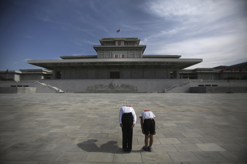 FILE - Two North Korean schoolchildren bow and pay respects to their late leaders Kim Il Sung and Kim Jong Il whose bodies lie embalmed in the mausoleum, the Kumsusan Palace of the Sun in Pyongyang, North Korea, on July 25, 2013. North Korea’s Kim Jong Un's train journey to Russia has a storified history. The tradition of train travel extends across the generations. That’s in evidence at the massive Kumsusan Palace of the Sun, where reconstructions of Kim Jong Un’s father’s and grandfather’s train cars, and the leaders’ preserved and displayed remains, are enshrined. (AP Photo/Wong Maye-E, File)