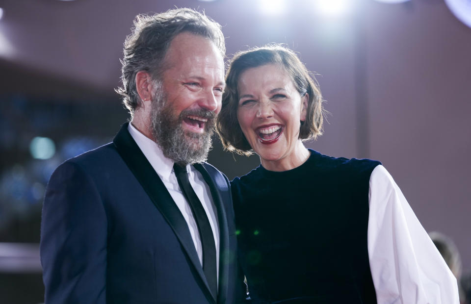 FILE - In this Sept, 3, 2021 file photo Peter Sarsgaard, left, and Maggie Gyllenhaal pose for photographers upon arrival at the premiere of the film 'The Lost Daughter' during the 78th edition of the Venice Film Festival in Venice, Italy. (AP Photo/Domenico Stinellis, File)