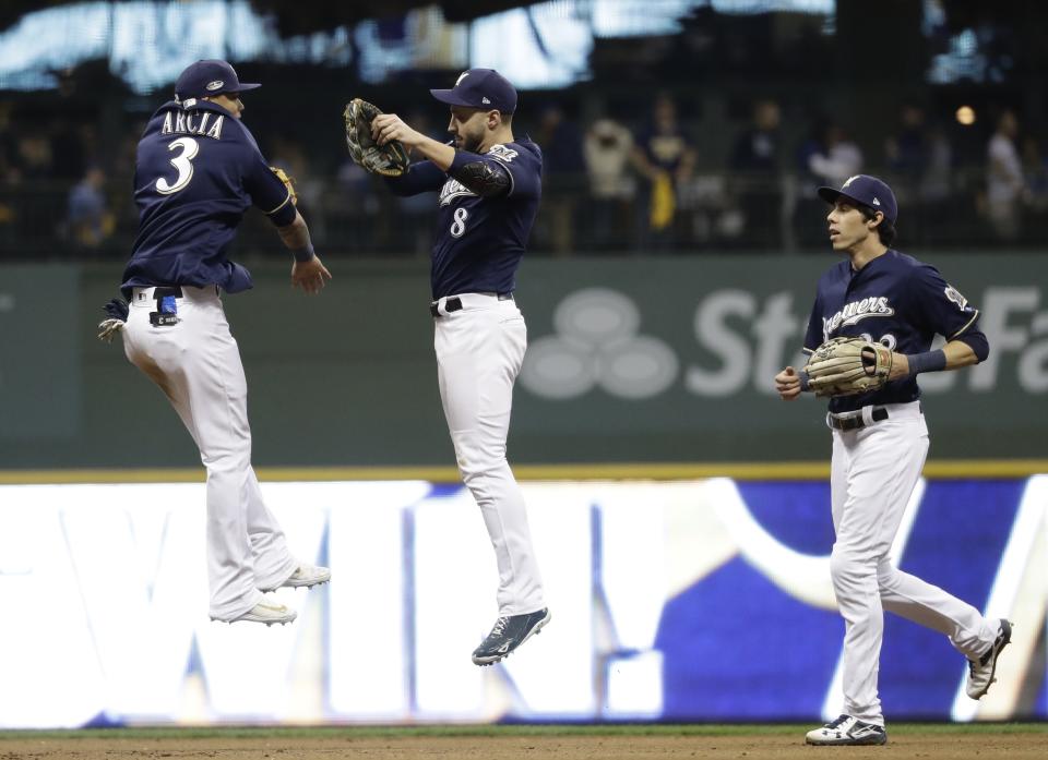 Milwaukee Brewers' Ryan Braun, Orlando Arcia and Christian Yelich celebrate after Game 1 of the baseball National League Championship Series on Friday, Oct. 12, 2018, in Milwaukee. The Brewers won 6-5 to take a 1-0 lead. (AP Photo/Matt Slocum)