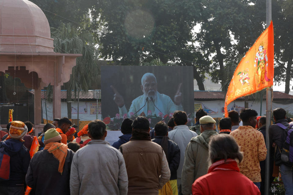 Hindu devotees watch   on a big screen as India's Prime Minister Narendra Modi attends the inauguration of the Hindu Lord Ram temple, in Ayodhya, India, Jan. 22, 2024. / Credit: ADNAN ABIDI/REUTERS