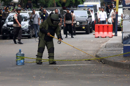 A bomb squad policeman inspect a bomb suspected object at location where a suspected supporter of Islamic State attacked policemen in Tangerang, Indonesia's Banten province, October 20, 2016, in this picture taken by Antara Foto. Antara Foto/Muhammad Iqbal/via REUTERS
