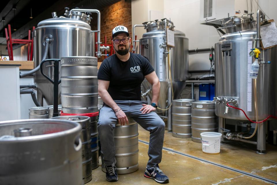 Seth Blewitt, owner and brewer, sits on a keg in the brewing area inside of Old Capital Brewing on Paint Street on March 26, 2024, in Chillicothe, Ohio.