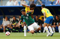 <p>Mexico’s Carlos Vela in action with Brazil’s Willian and Fagner REUTERS/Carlos Garcia Rawlins </p>