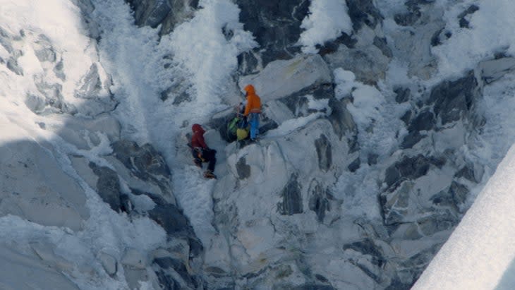 Conrad Anker (left) sitting at the belay next to David Lama (right) high on Lunag Ri, right as it's becoming clear that Conrad is having a heart attack.