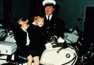 <p>The prince salutes on a motorbike with his big brother William while visiting the police force in Windsor. <br></p>