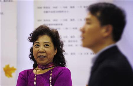 A woman looks at a man during a matchmaking event for middle-aged singles and seniors, sponsored by Shanghai's government, in Shanghai November 9, 2013. REUTERS/Carlos Barria