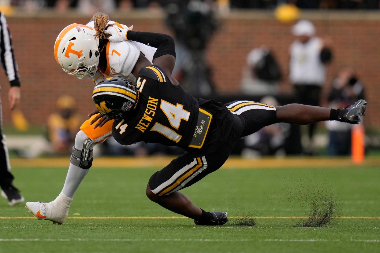 Tennessee quarterback Joe Milton III (7) is pulled down by Missouri linebacker Triston Newson during the first half of an NCAA college football game Saturday, Nov. 11, 2023, in Columbia, Mo. (AP Photo/Jeff Roberson)