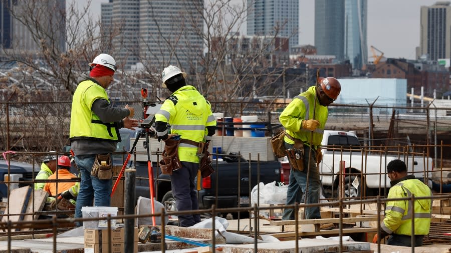 <sub>Construction workers prepare a recently poured concrete foundation on Friday, March 17, 2023, in Boston. But many jobs are hard for former convicts to get, as employers lock them out based on their prison record. (AP Photo/Michael Dwyer)</sub>