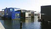 In this photo taken Wednesday, March 28, 2012 amphibious homes float on the harbor in the IJburg neighborhood in Amsterdam. IJburg is a new district in the eastern part of town completely surrounded by water. The Netherlands, a third of which lies below sea level, has been managing water since the Middle Ages and has thus emerged as a pioneer in the field, exporting its expertise to Indonesia, China, Thailand, Dubai and the Republic of the Maldives, an Indian Ocean archipelago that with a maximum elevation of about 2 meters (8 feet) is the world's lowest country. (AP Photo/Margriet Faber)