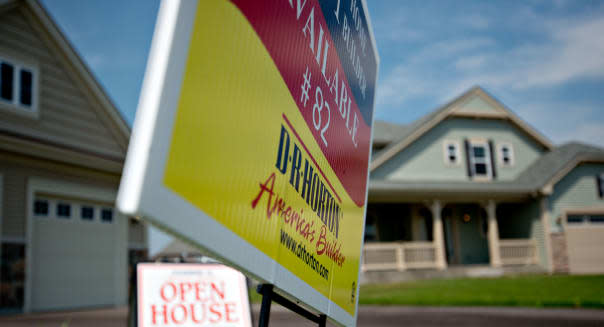 A &#39;Open House&#39; sign stands outside a new home for sale in the D.R. Horton Inc. Cambridge at Southbury development in Oswego, Illinois, U.S., on Tuesday, Aug. 20, 2013. The Commerce Department is scheduled to release new home sales figures on Aug. 23. Photographer: Daniel Acker/Bloomberg via Getty Images