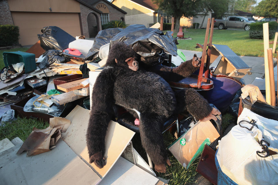 Debris and possessions are piled&nbsp;at the curb.