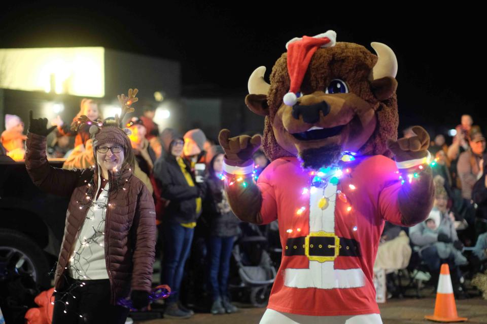 The crowd cheers as the annual Parade of Lights marches through the square Saturday night in downtown Canyon.