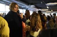 Models get ready in the backstage prior to the start of the K-Way men's Fall-Winter 2022-23 fashion show, unveiled during the Fashion Week in Milan, Italy, Monday, Jan. 17, 2022. (AP Photo/Antonio Calanni)