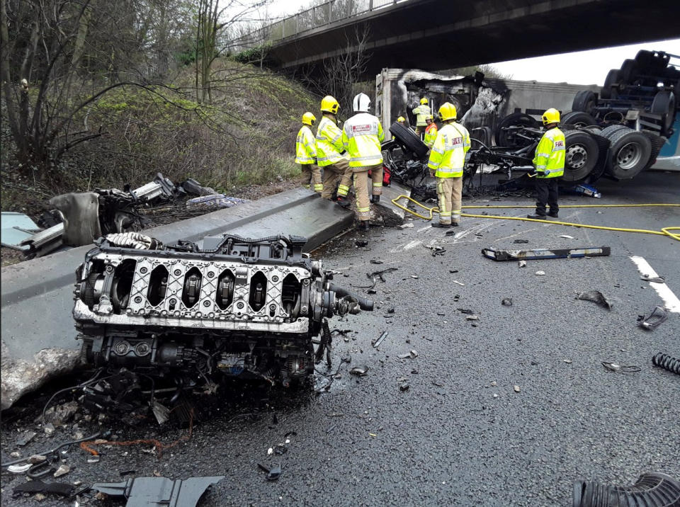 Dramatic photographs show the aftermath of a horror motorway crash which has left a lorry split in half. See SWNS story SWLNcrash; Emergency services were called to the M6 in Staffordshire following the smash involving a lorry which overturned and caught fire earlier today (Sun).  Traffic was stopped in both directions between Junction 12 for Cannock and Junction 13 for Stafford as police and ambulance crews rushed to the scene. Shocking images show how the HGV was completely split in two by the impact of the collision which also left its engine strewn across the carriageway. 