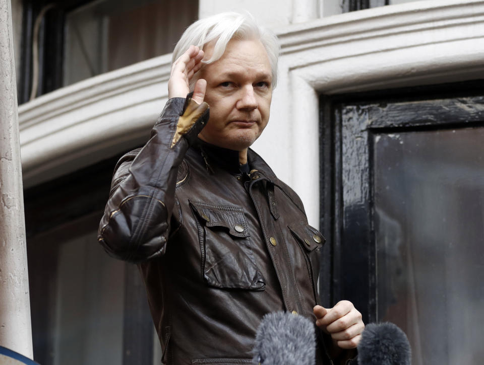 FILE - In this May 19, 2017, file photo, WikiLeaks founder Julian Assange greets supporters from a balcony of the Ecuadorian embassy in London. Federal prosecutors are fighting a request to unseal an apparent criminal complaint against WikiLeaks founder Julian Assange. In papers filed Monday, Nov. 26, 2018, in Alexandria, Va., prosecutors argued that the public has no right to know whether a person has been charged until there has been an arrest. (AP Photo/Frank Augstein, File)