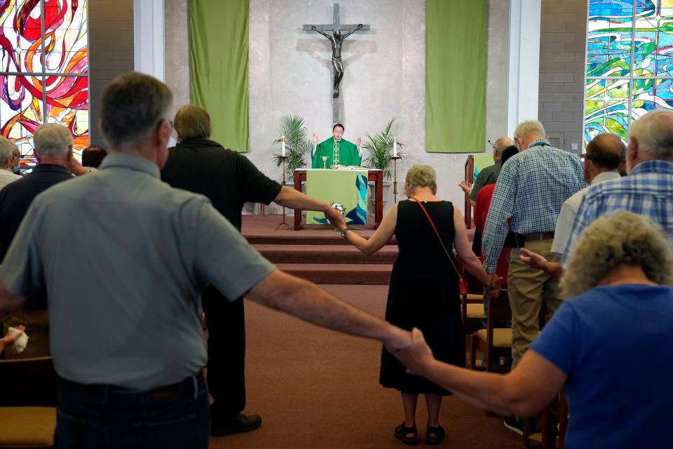 Jul 3, 2022; Columbus, Ohio, USA;  Fr. Jimmy Hsu, CSP leads Catholic mass at the Newman Center, the parish and student ministry at Ohio State on July 3, 2022. The diocese is being taken from the Paulist fathers, an order of Catholic priests, who have run it for 65 years.  Mandatory Credit: Adam Cairns-The Columbus Dispatch