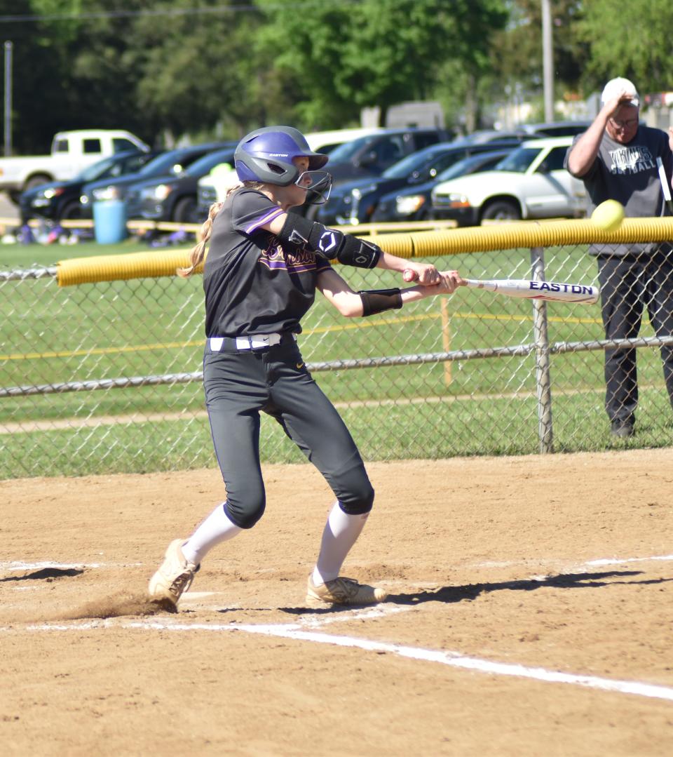 Bronson's Ashlynn Harris watches a ball she hit fly to deep right center on her way to a triple Tuesday