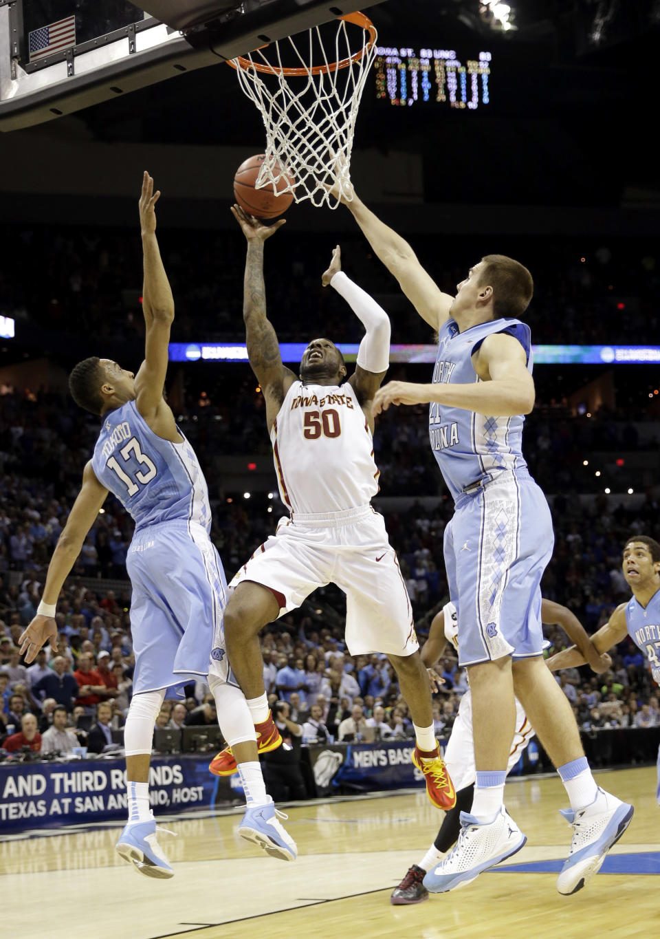 Iowa State's DeAndre Kane (50) makes the game-winning basket as North Carolina's J.P. Tokoto (13) and North Carolina's Jackson Simmons (21) defend during the second half of a third-round game in the NCAA college basketball tournament Sunday, March 23, 2014, in San Antonio. Iowa State won 85-83. (AP Photo/David J. Phillip)