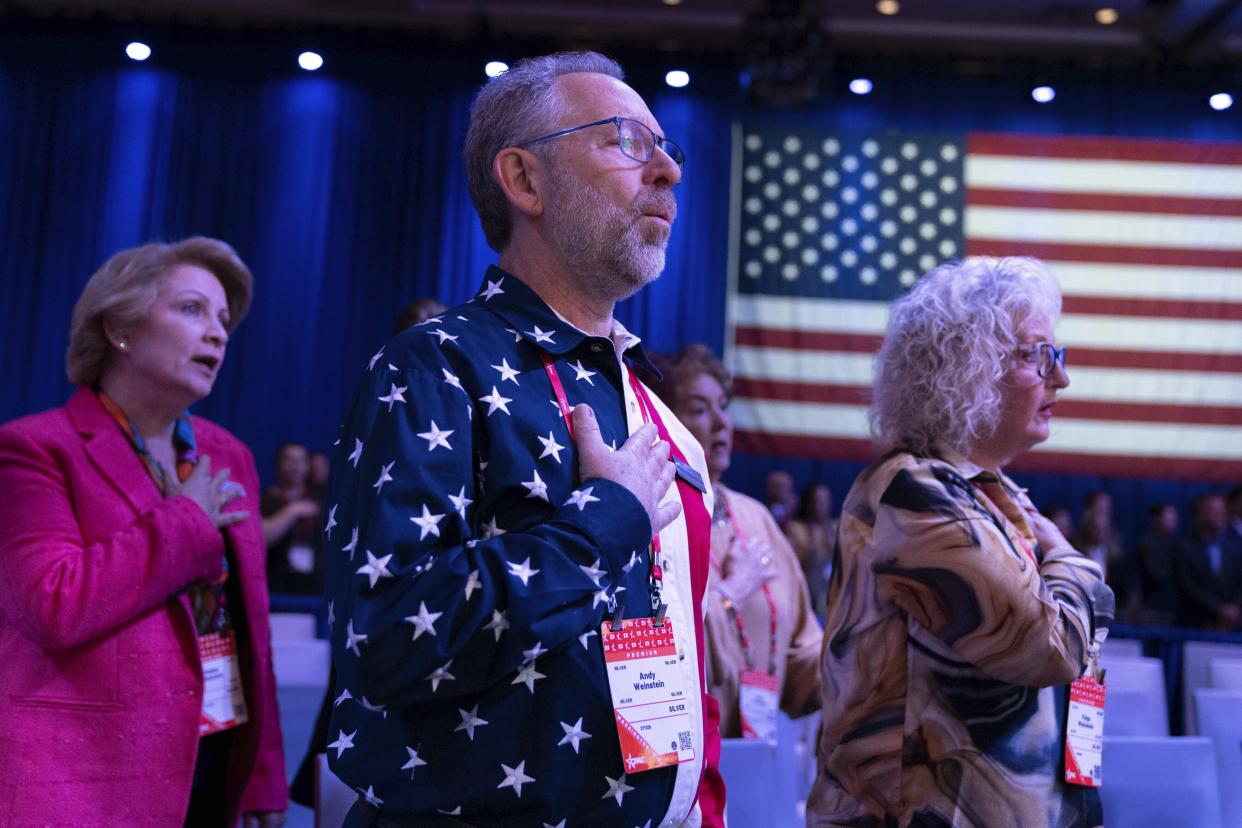 FILE - People attending the Conservative Political Action Conference, CPAC 2023, sing the national anthem during the opening session, at the National Harbor, in Oxon Hill, Md., Thursday, March 2, 2023. (AP Photo/Jose Luis Magana, File)