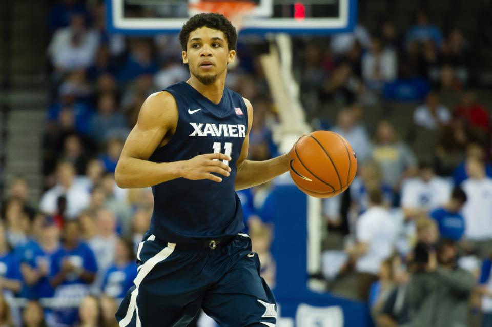 Mar 7, 2015; Omaha, NE, USA; Xavier Musketeers guard Dee Davis (11) dribbles against the Creighton Bluejays at CenturyLink Center Omaha on March 7, 2015.