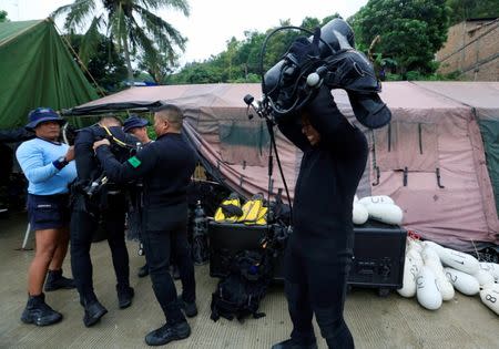 Rescue team members prepare their diving gear before a search operation for the missing passengers after a ferry sank earlier this week in Lake Toba in Simalungun, North Sumatra, Indonesia, June 23, 2018. REUTERS/Beawiharta