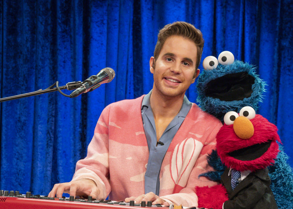 This image released by Sesame Workshop shows muppet character Elmo, clockwise from bottom right, Cookie Monster and actor Ben Platt during a taping of Elmo's new show called “The Not Too Late Show with Elmo.” It begins streaming May 27 on HBO Max. (Richard Termine/Sesame Workshop via AP)