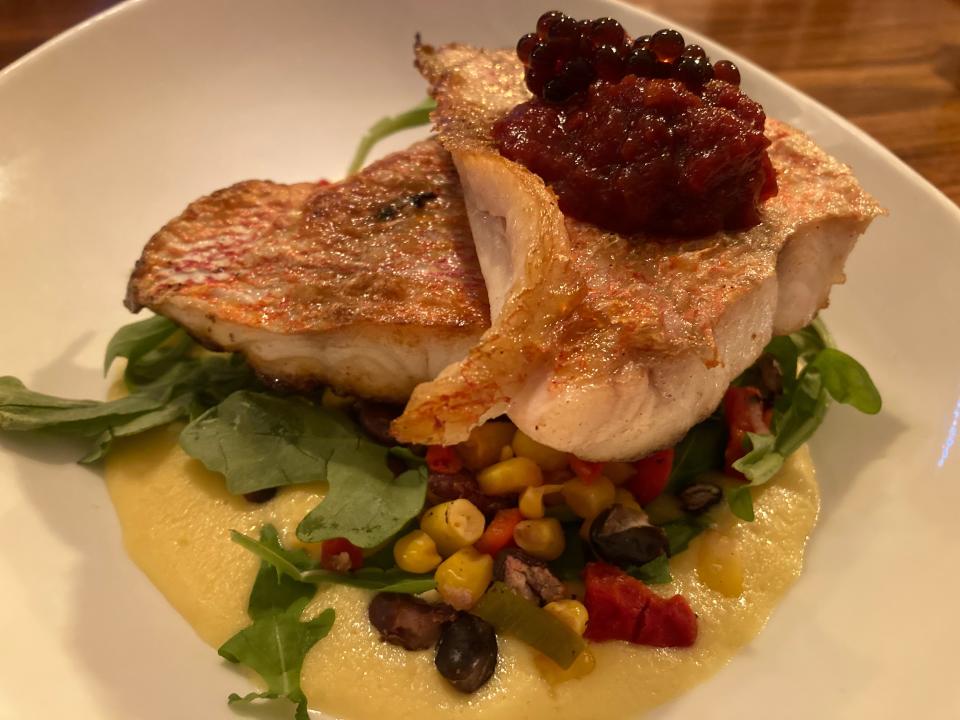 Red snapper in herbed white-wine butter with a corn cream sauce and black bean, roasted corn and roasted red-pepper salad, shown Oct. 20, 2023 at the North Hero House.