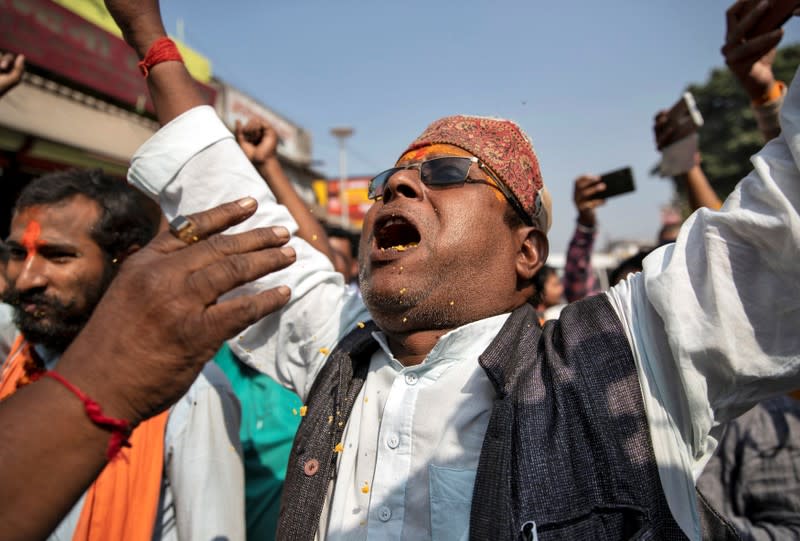 A Hindu devotee celebrates after Supreme Court's verdict on a disputed religious site, in Ayodhya
