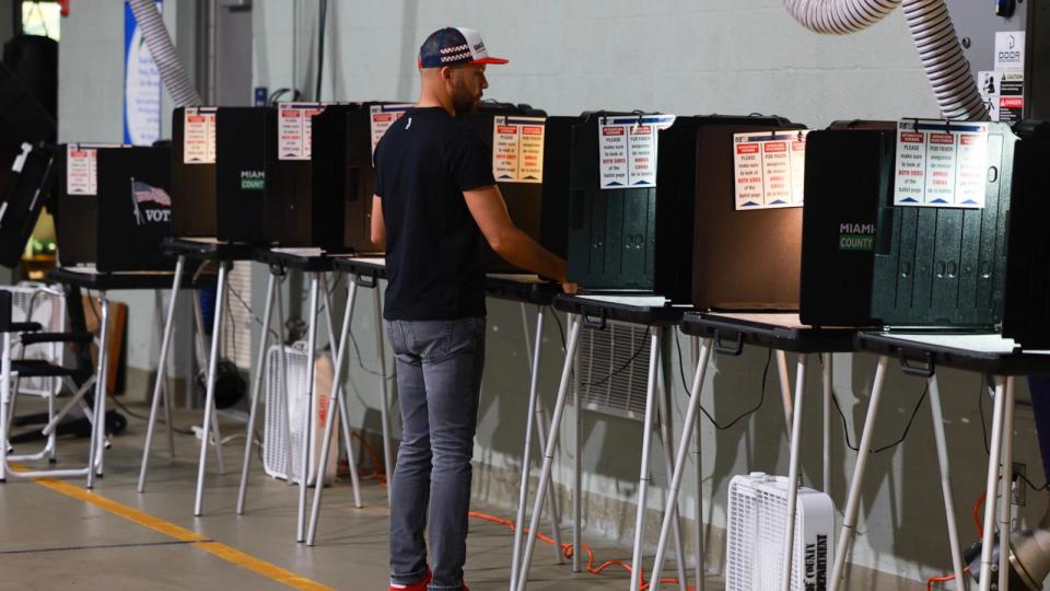PHOTO: A poll worker prepares a voting booth as he waits for voters to arrive at the Miami Beach Fire Station 4 to cast their ballot during the primary, March 19, 2024, in Miami Beach. (Joe Raedle/Getty Images)