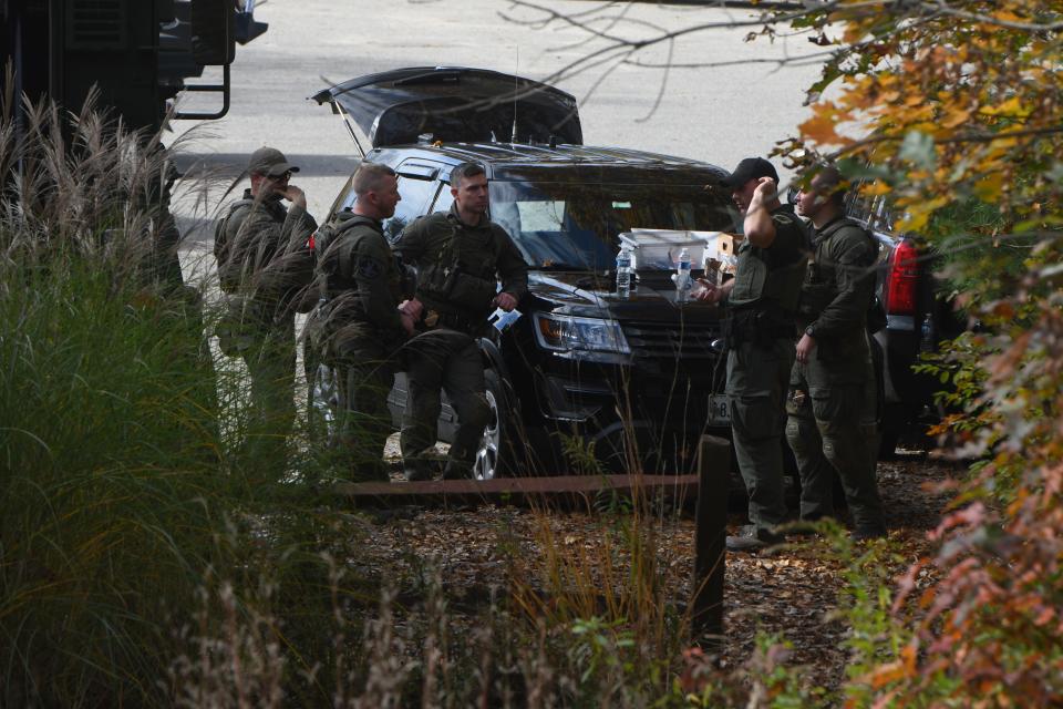 Law enforcement agents surround an area in Lisbon, Maine, Friday, Oct. 27, 2023, at the boat launch where the vehicle of Robert Card was found after multiple mass shootings. Hundreds of law enforcement agents were scouring communities around Lewiston, Maine for Robert Card, an "armed and dangerous" suspect in two deadly shootings at a bowling alley and a bar as residents sheltered in place in their homes.