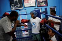 Teacher Alan (L) trains children on a boxing ring during an exercise session at a boxing school, in the Mare favela of Rio de Janeiro, Brazil, June 2, 2016. REUTERS/Nacho Doce