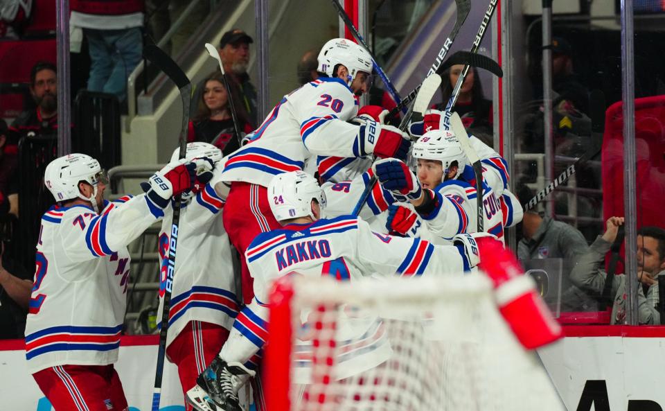 May 9, 2024; Raleigh, North Carolina, USA; New York Rangers left wing Artemi Panarin (10) is congratulated by his teammates after his goal in the first overtime against the Carolina Hurricanes in game three of the second round of the 2024 Stanley Cup Playoffs at PNC Arena. Mandatory Credit: James Guillory-USA TODAY Sports