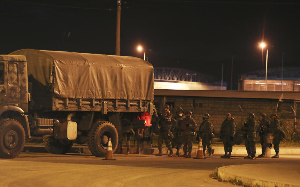 Soldiers leave the prison "Centro de Rehabilitacion Social Regional Centro Norte Cotopaxi" where deadly riots broke out inside, two days prior in Latacunga, Ecuador, early Thursday, Feb. 25, 2021. Ecuador experienced its deadliest prison riots ever this week when seemingly coordinated fights broke out in facilities in three different cities, leaving 79 inmates dead as of Wednesday and exposing the limited control that authorities have over people behind bars. (AP Photo/Dolores Ochoa)