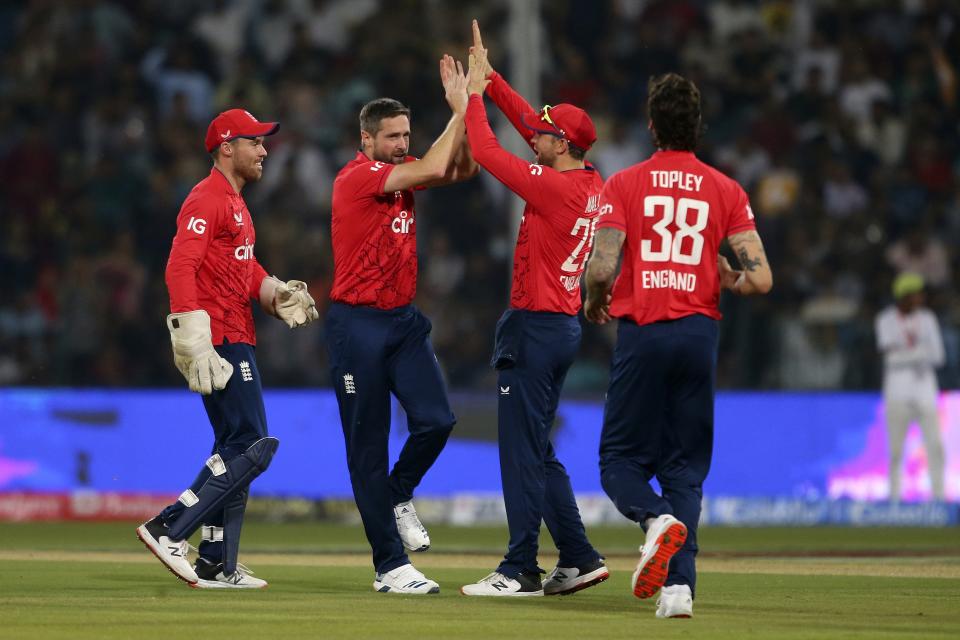 England's Chris Woakes, second left, celebrates with teammates after taking the wicket of Pakistan's Babar Azam during the seventh twenty20 cricket match between Pakistan and England, in Lahore, Pakistan, Sunday, Oct. 2, 2022. (AP Photo/K.M. Chaudary)