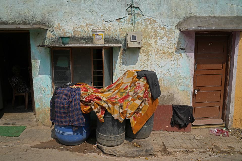 Barrels filled with water are covered with blankets to prevent them from the heat in a low-income settlement of Whitefield neighborhood, in Bengaluru, India, Monday, March 11, 2024. Bengaluru is witnessing an unusually hot February and March, and in the last few years, it’s received little rainfall in part due to human-caused climate change. (AP Photo/Aijaz Rahi)