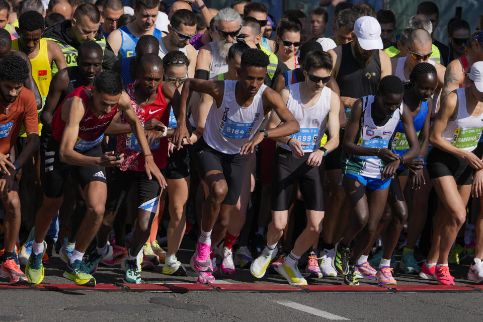 Tachlowini Gabriyesos, Eritrean born long distance runner, center, runs during the half marathon race in Belgrade, Serbia, Sunday, April 23, 2023. Gabriyesos fled his native Eritrea to Israel when he was just 12 years old. Gabriyesos, who will be 25 in July, ran a half-marathon race on Sunday at the Belgrade Marathon as part of a United Nations refugee agency team at the event. (AP Photo/Darko Vojinovic)