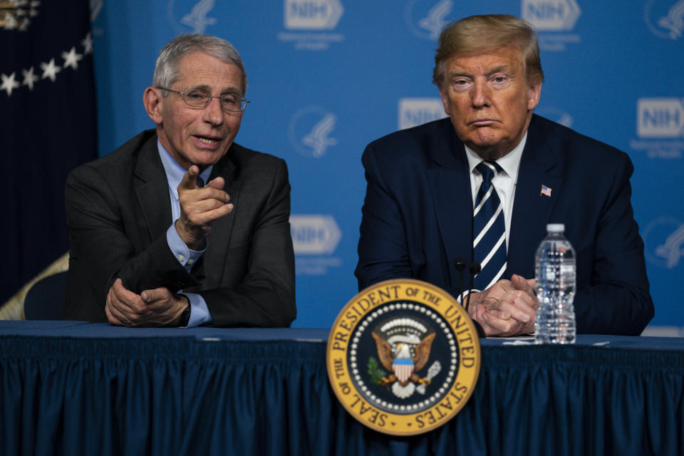 President Donald Trump listens to Dr. Anthony Fauci, director of the National Institute of Allergy and Infectious Diseases, during a briefing on the coronavirus at the National Institutes of Health, Tuesday, March 3, 2020, in Bethesda, Md. (AP Photo/Evan Vucci)