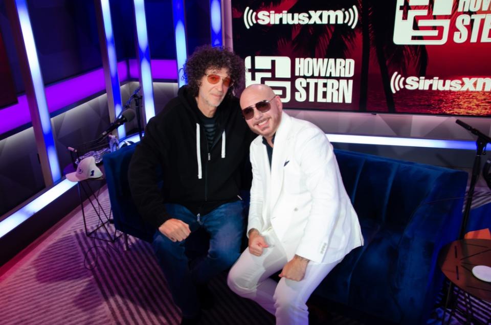 MIAMI BEACH, FLORIDA – MAY 02: Howard Stern and Pitbull pose at The Howard Stern Show at the SiriusXM Miami studios on May 02, 2023 in Miami Beach, Florida. (Photo by Jason Kaplan/ Getty Images for SiriusXM)
