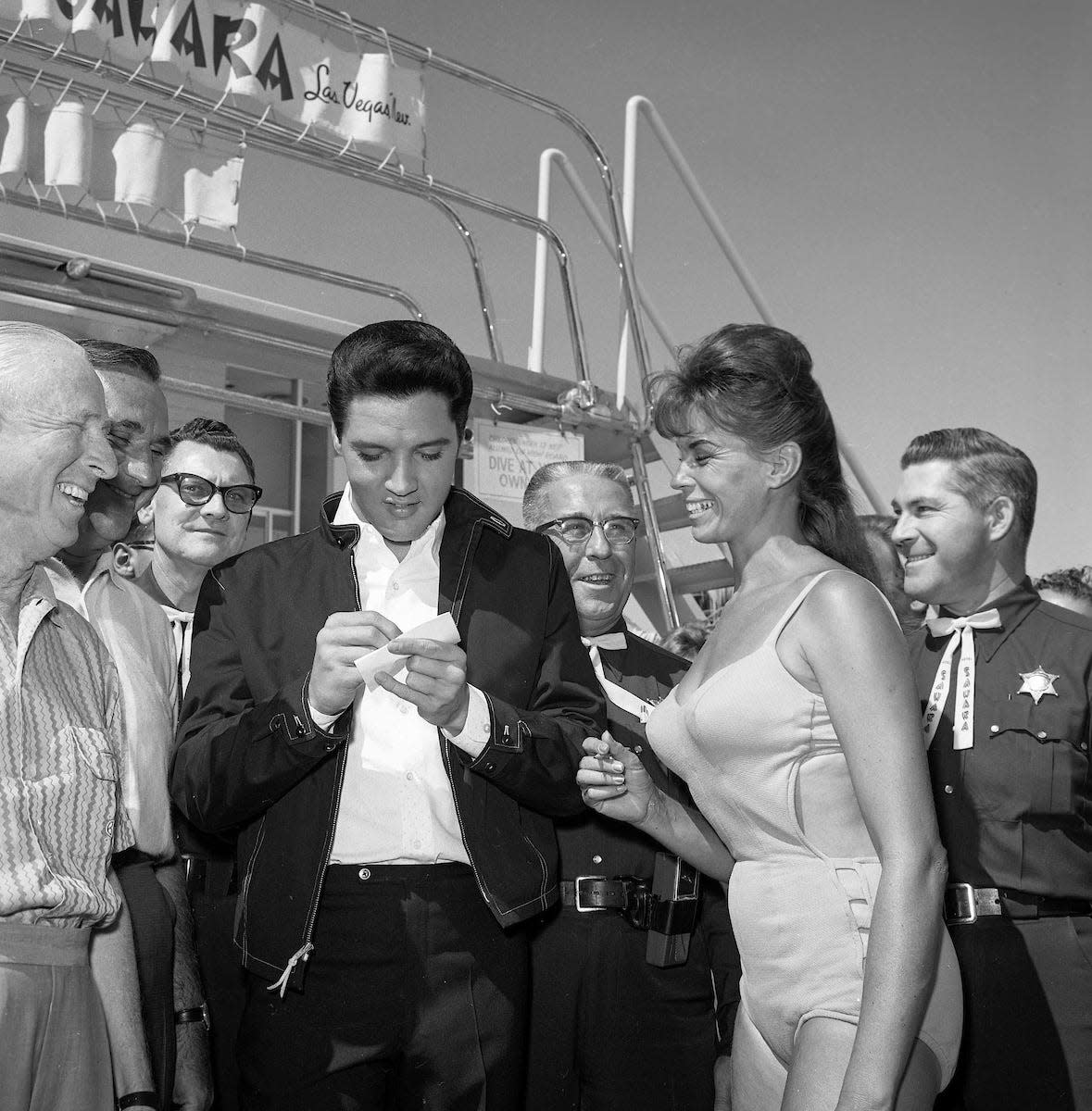 Elvis Presley signs autographs for guests poolside at the Sahara July 26, 1963. (Las Vegas News Bureau Collection, LVCVA Archive)
